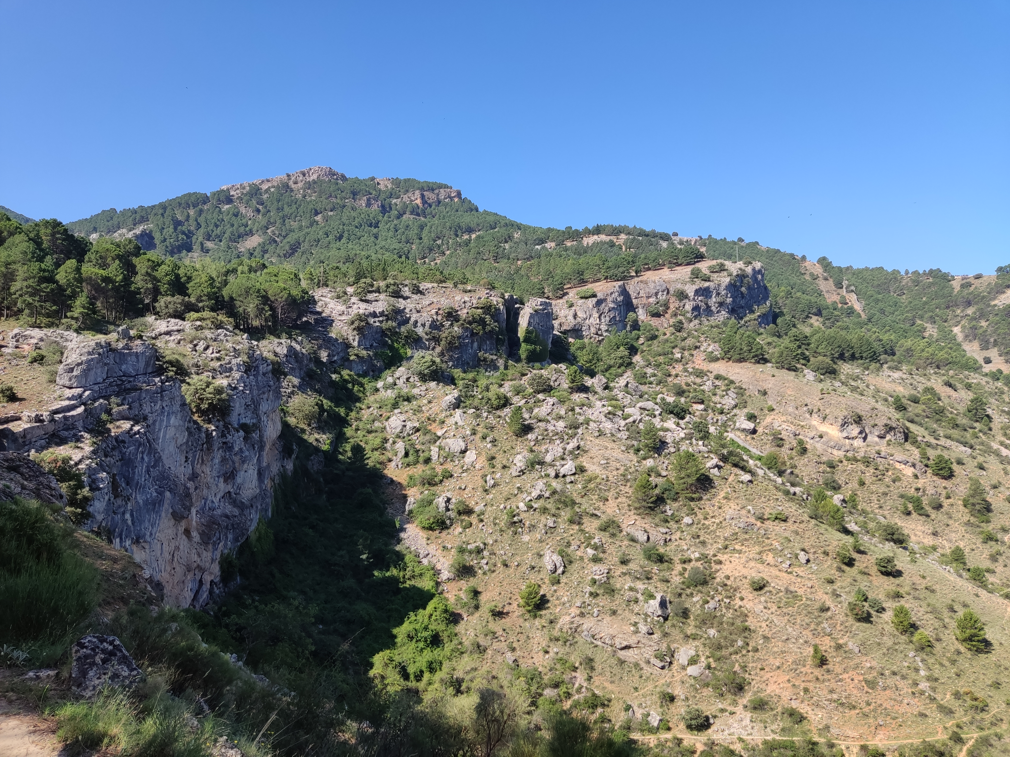 Cliff and mountains in the distance